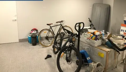 Cluttered garage before a fit out, bikes and boxes on the floor